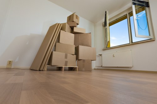 Professional office movers handling packed equipment in a Belgravia building