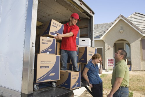 Staff wearing PPE while loading items into a removal van